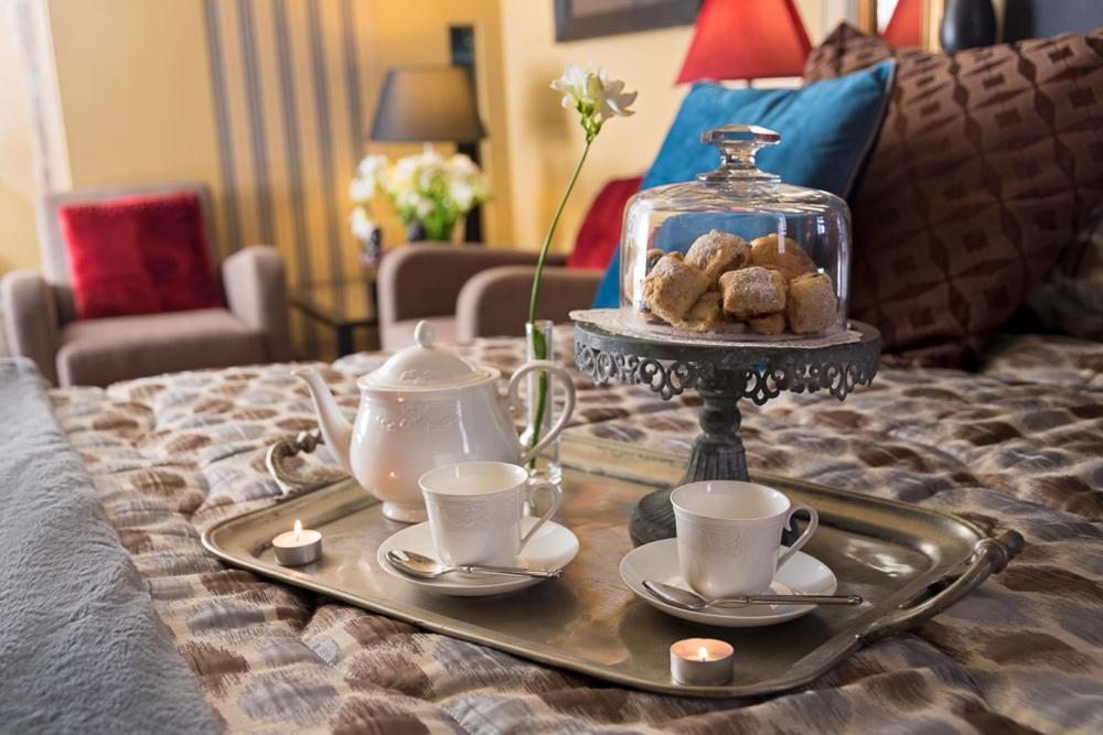 a tray with tea pots and cups on a bed at Torre Di Vico Residenza D'Epoca in Viterbo