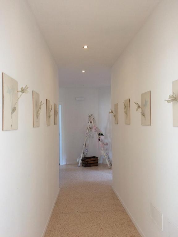 a hallway with paintings on a wall in a room at Joy Living in Sandra