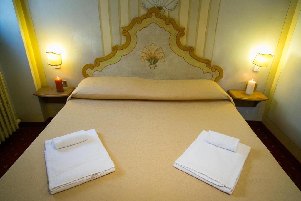Posteľ alebo postele v izbe v ubytovaní Hotel Posta R.T.A.