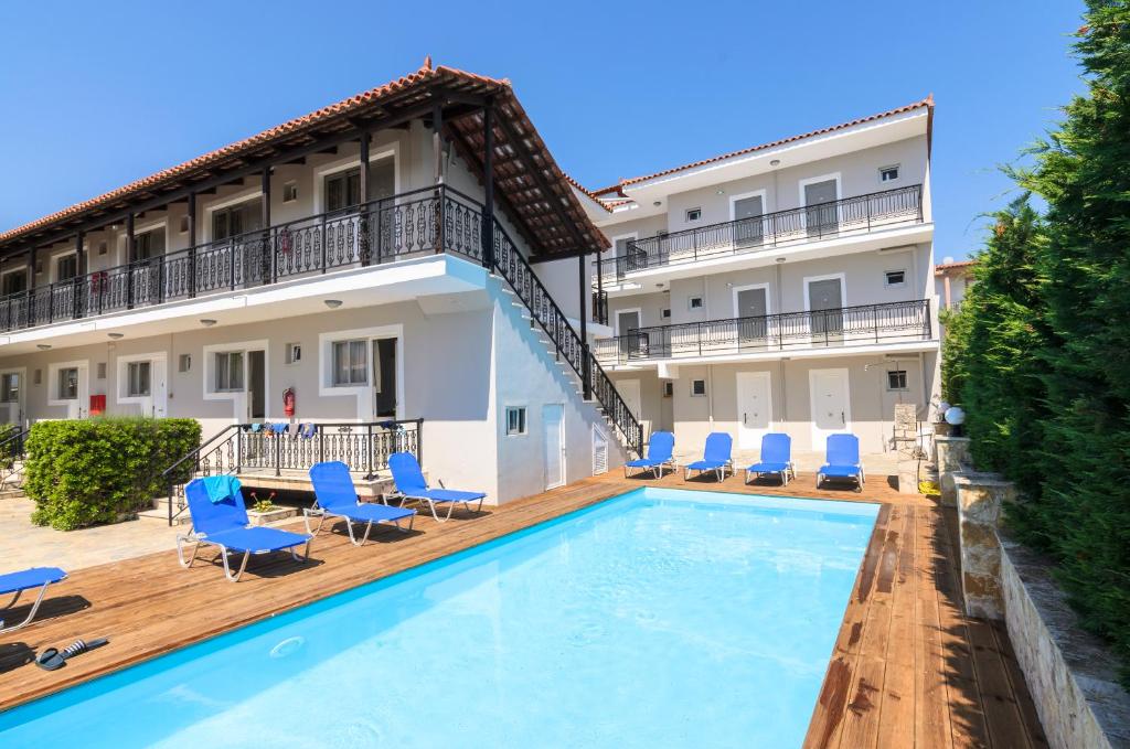 a hotel with a swimming pool in front of a building at Karras Livin in Laganas