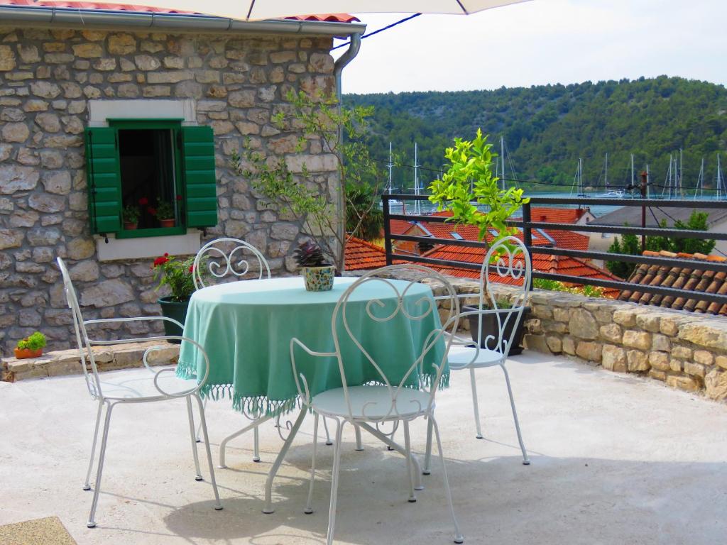 a table and chairs sitting on a patio at Holiday Home Anna in Skradin