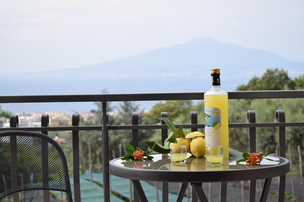 a bottle of wine and two glasses on a table at Sorrento Dolce Casa in Sorrento