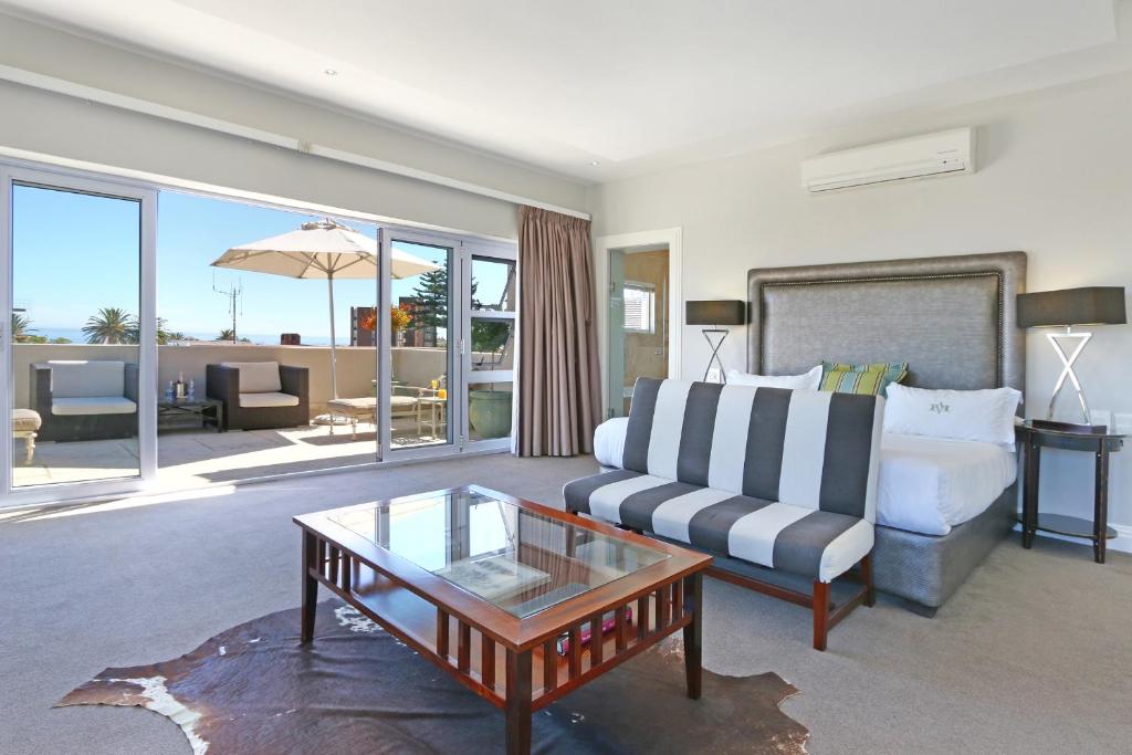 a living room with a couch and a coffee table at Vetho Villa in Cape Town