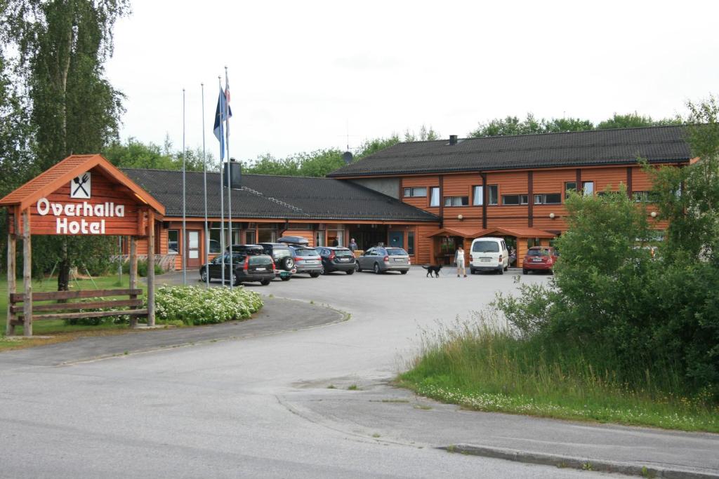 a hotel with cars parked in front of a building at Overhalla Hotel in Overhalla 