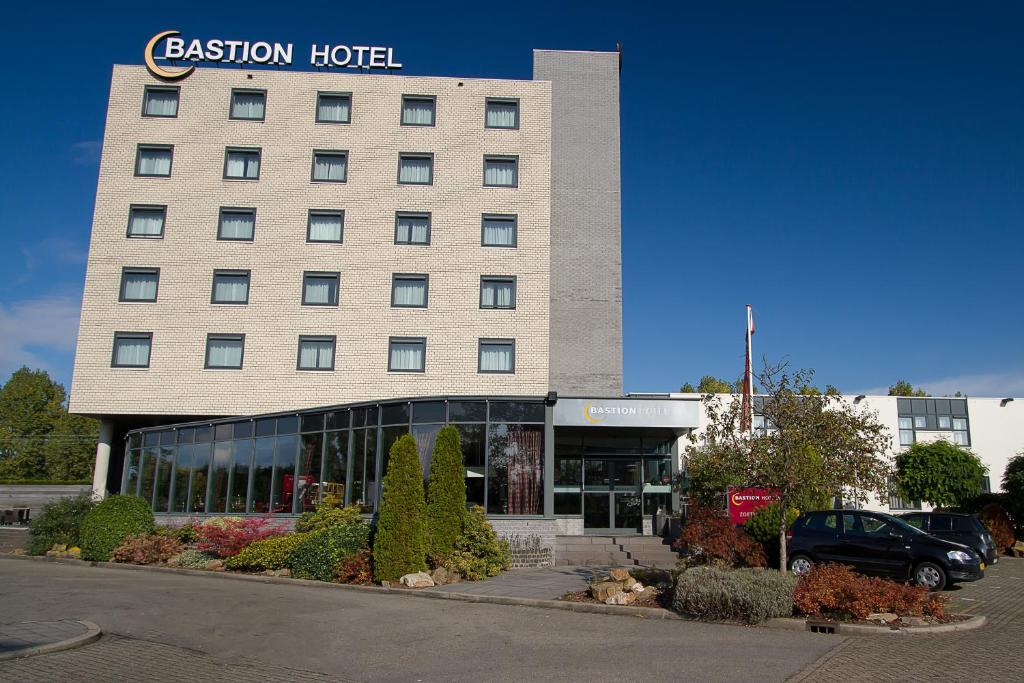 a hotel building with a car parked in front of it at Bastion Hotel Zoetermeer in Zoetermeer