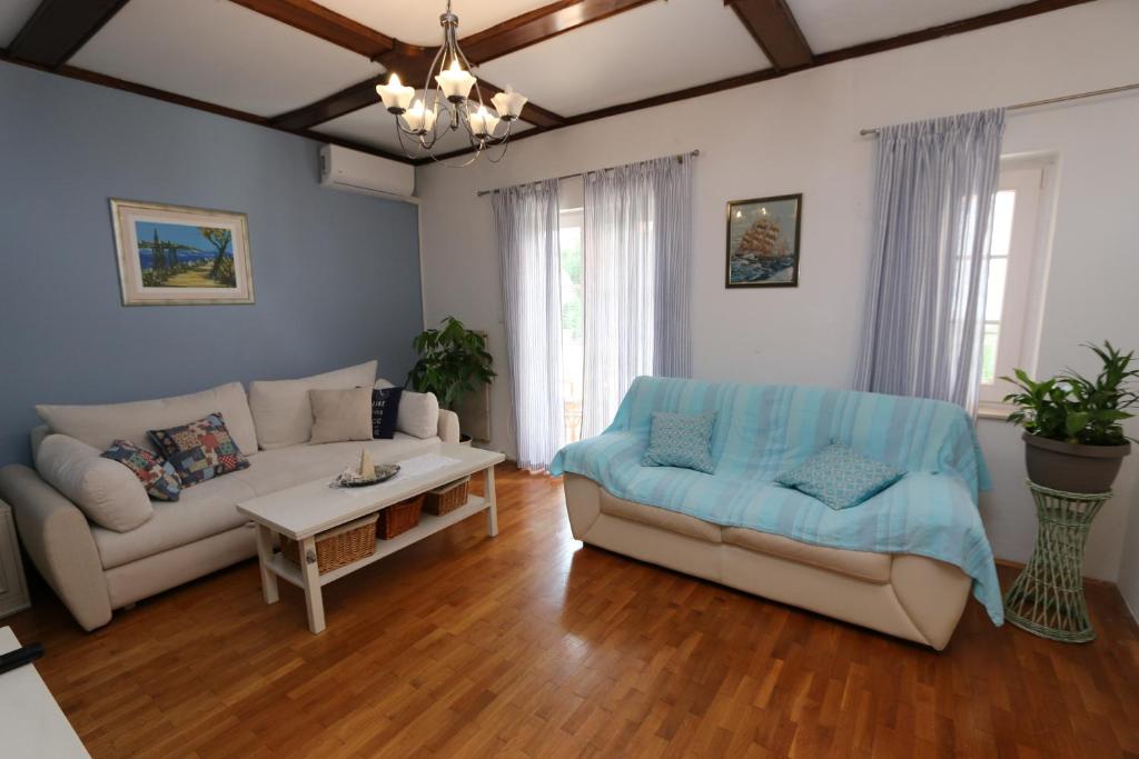 a living room with a couch and a table at Apartment Pijer in Novalja