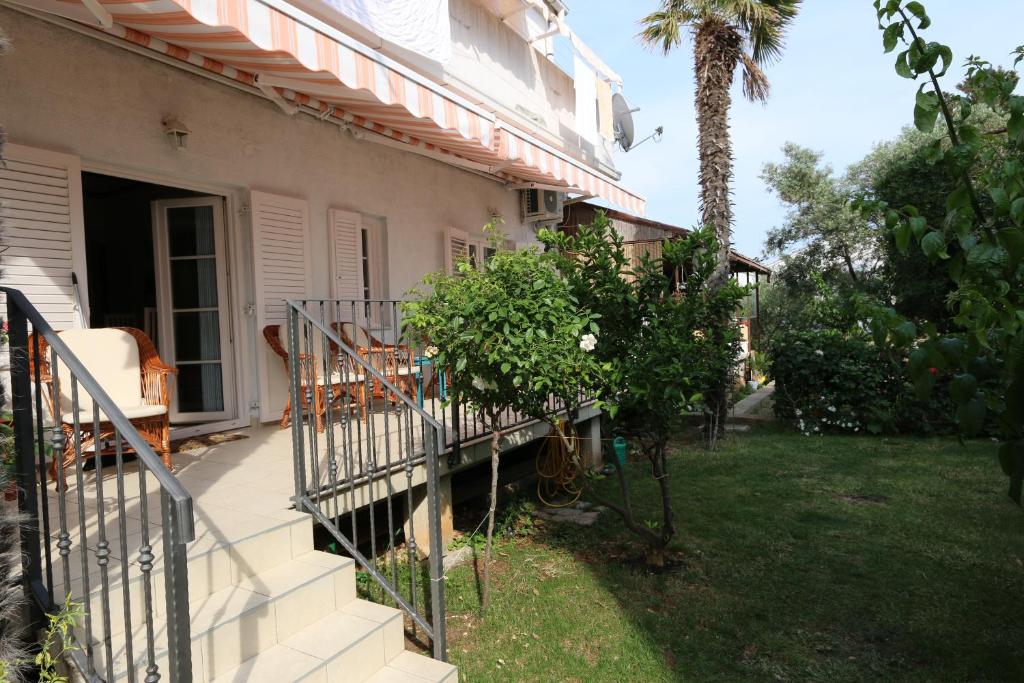 a house with a staircase leading to a yard at Apartment Pijer in Novalja