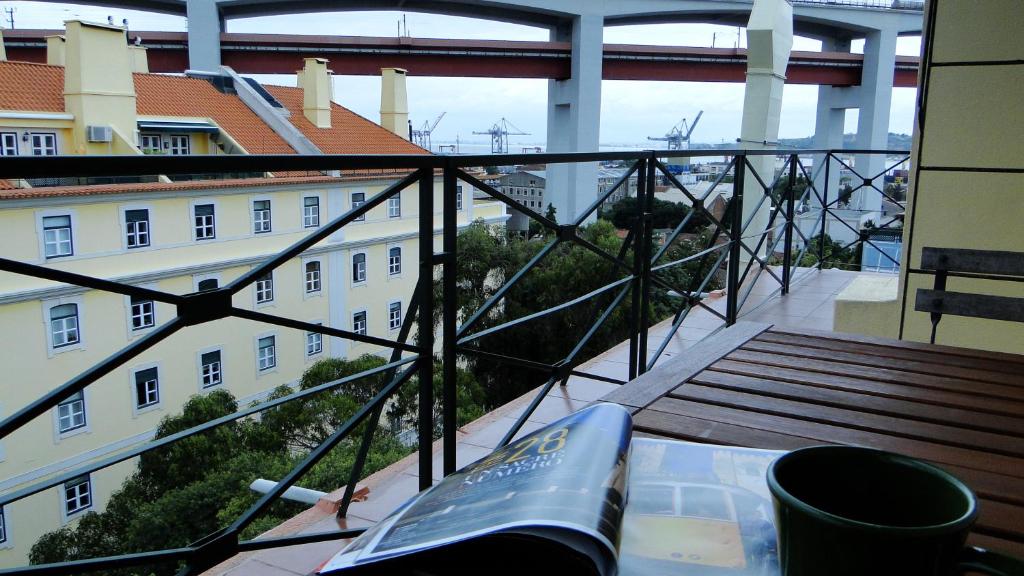 a balcony with a table and a view of a building at Riverfront studio in Lisbon