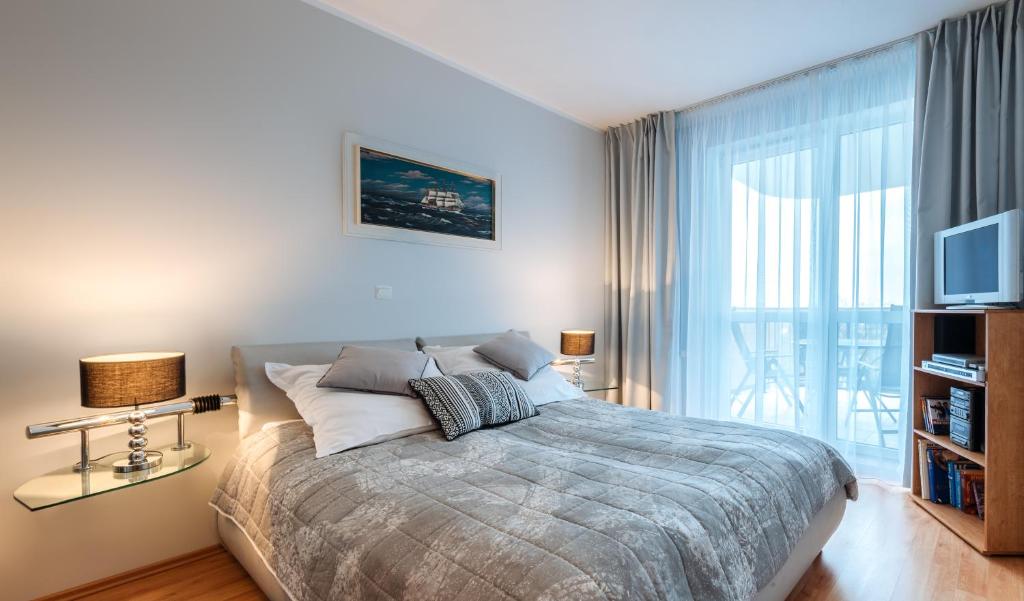 Posteľ alebo postele v izbe v ubytovaní Apartament Morski