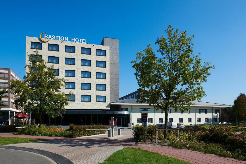 a building with a sign on top of it at Bastion Hotel Breda in Breda