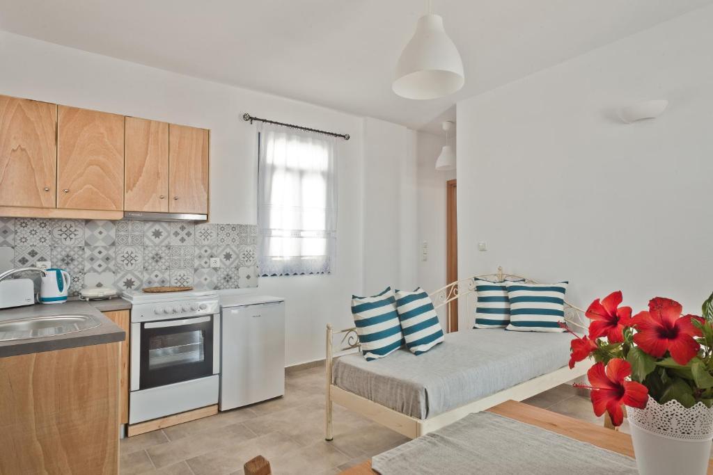 a kitchen with a couch in the middle of a room at Alisachni Villas in Lefkos Karpathou