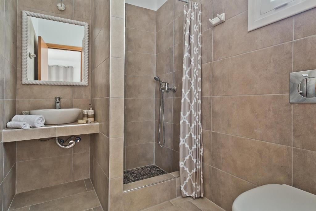 a bathroom with a shower and a sink at Alisachni Villas in Lefkos Karpathou