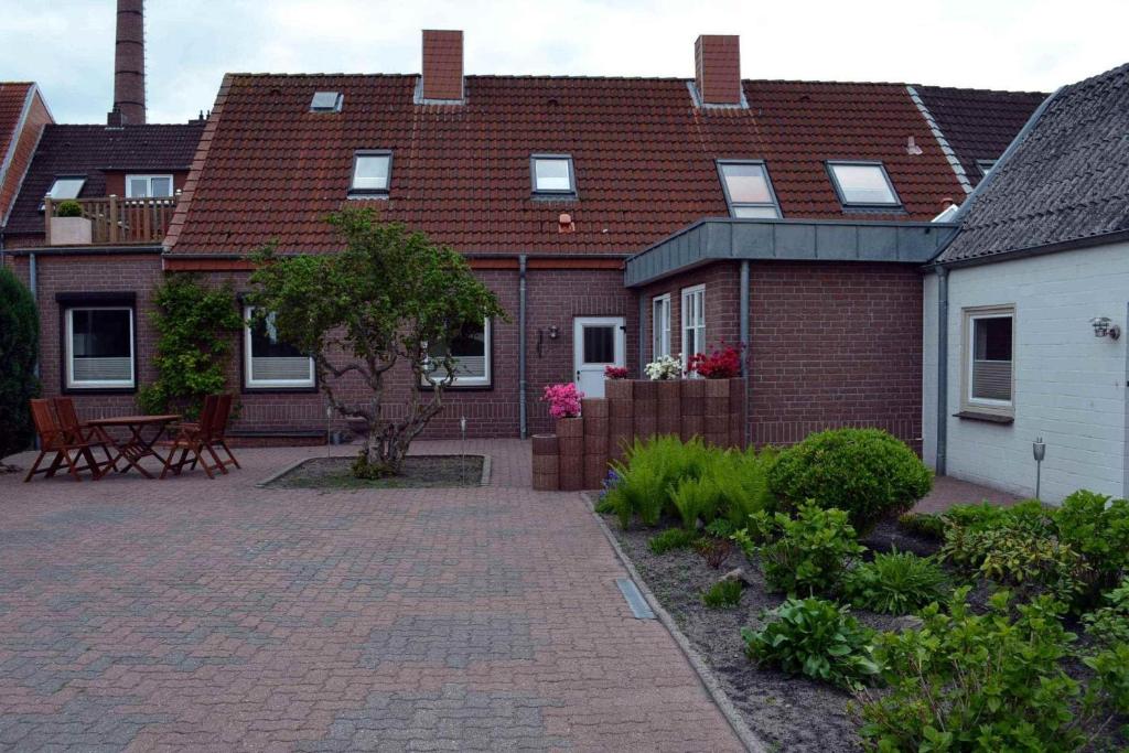 a brick house with a patio and a brick driveway at Ferienhaus-Am-Strand in Eckernförde