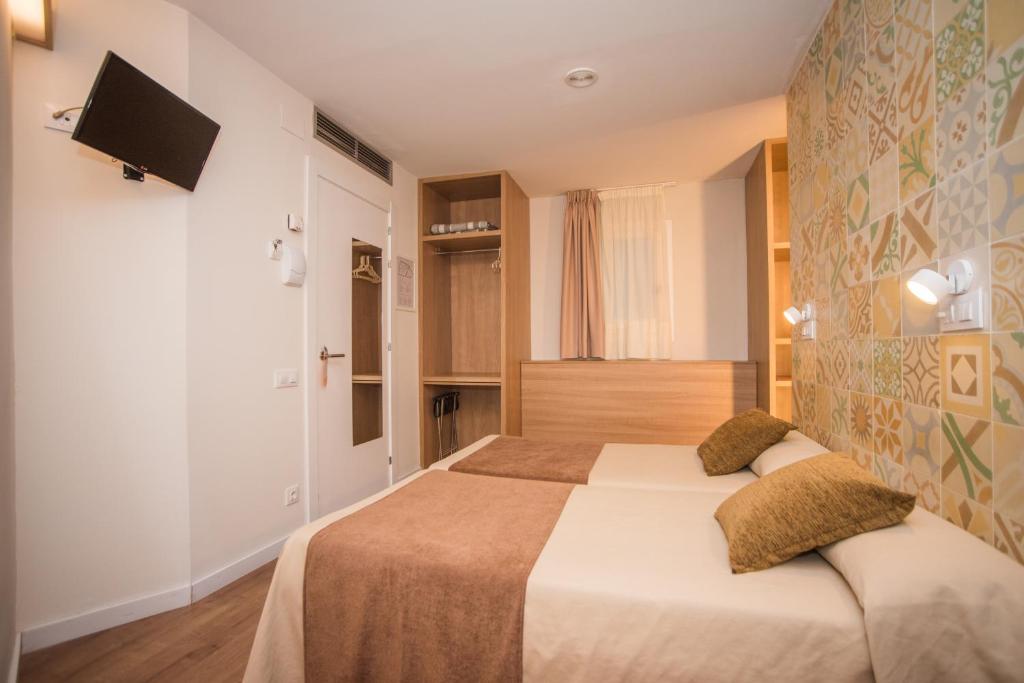 Posteľ alebo postele v izbe v ubytovaní Hostal Marenostrum