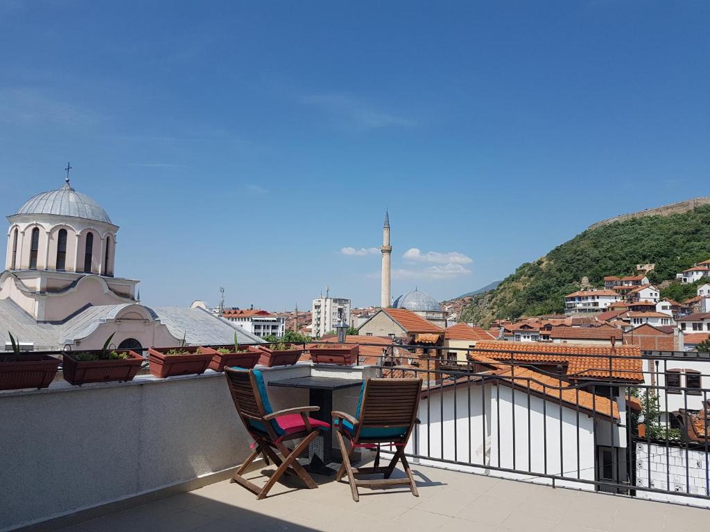 a table and chairs on the roof of a building at Guesthouse Hotel My Home in Prizren