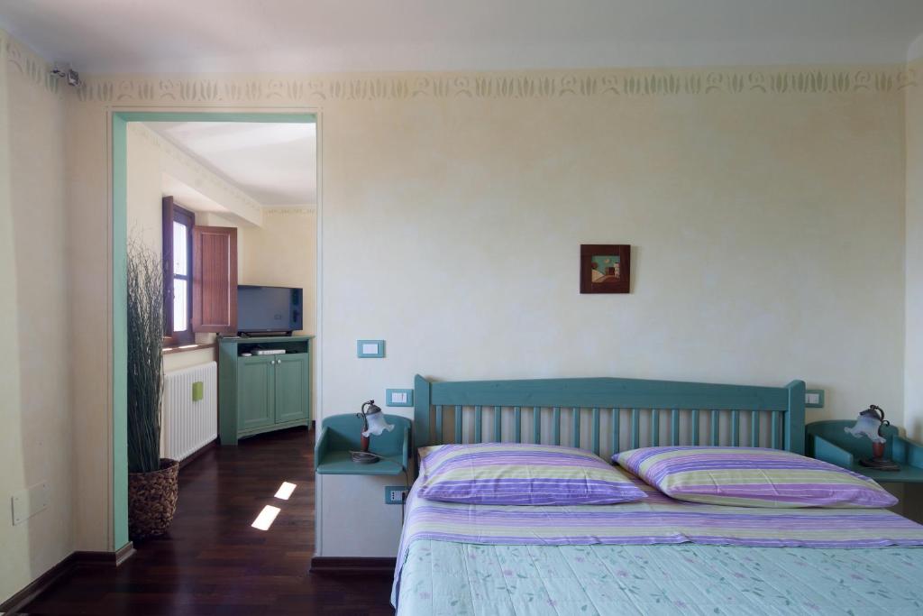 Postel nebo postele na pokoji v ubytování B&B La Pulce Dorata
