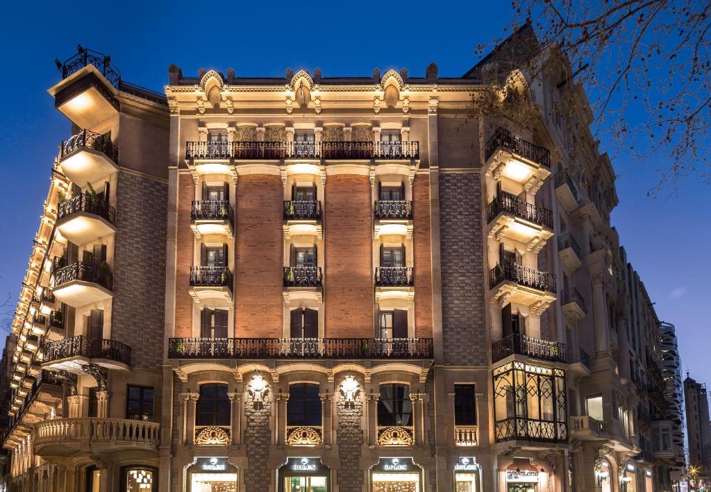 a facade of a building with lights on at Monument Hotel in Barcelona