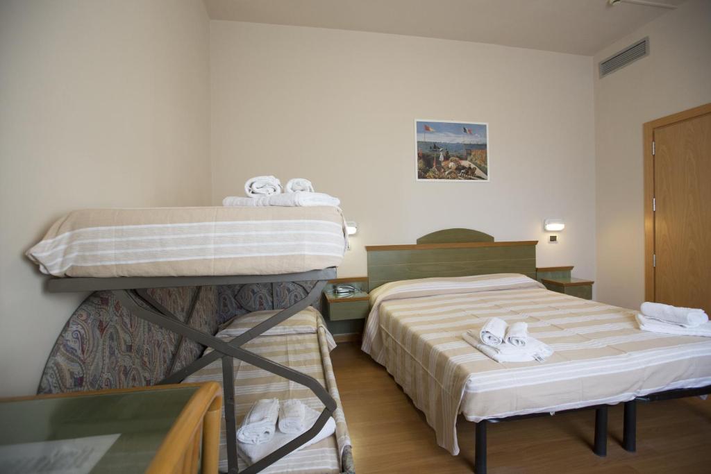 Postel nebo postele na pokoji v ubytování Hotel Impero