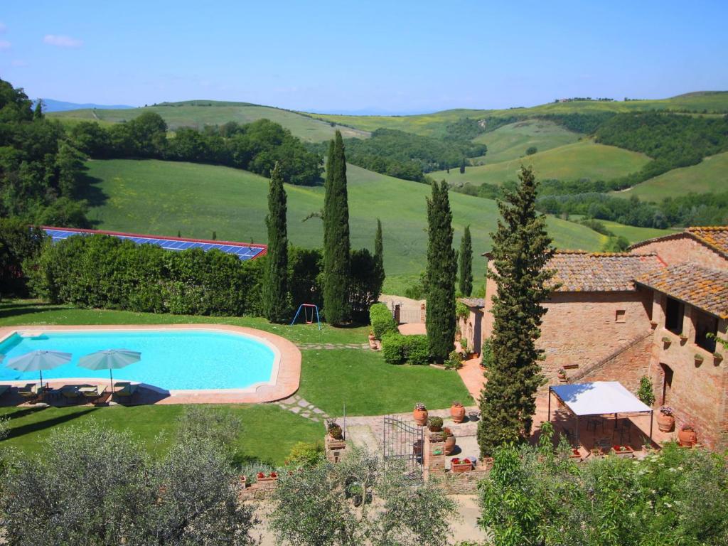 an external view of a villa with a swimming pool at Luxurious Farmhouse in Montalcino with Pool in Montalcino