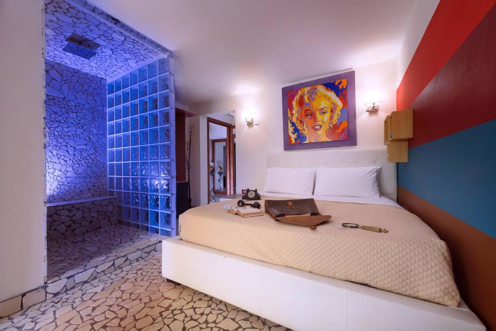 a bedroom with a bed and a blue wall at Diemme Studio in Salerno