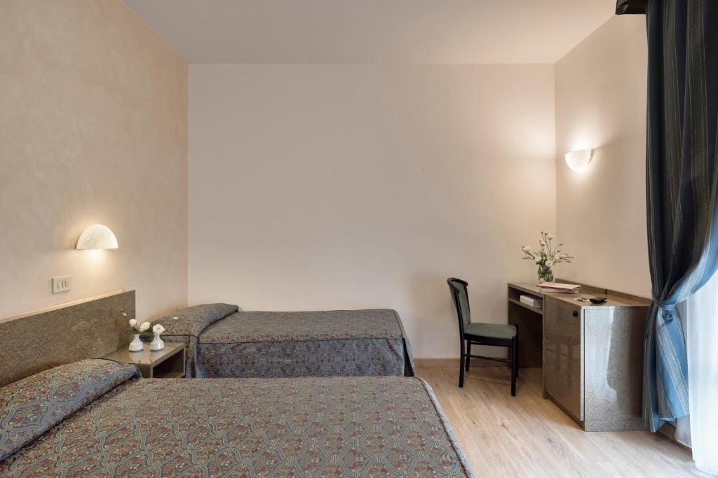 Postel nebo postele na pokoji v ubytování Hotel Garibaldi