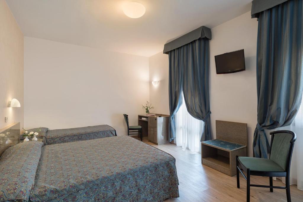 Postel nebo postele na pokoji v ubytování Hotel Garibaldi