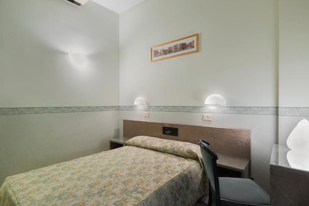 Postel nebo postele na pokoji v ubytování Hotel Garibaldi