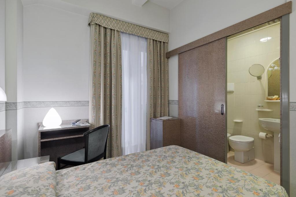 Postel nebo postele na pokoji v ubytování Hotel Garibaldi