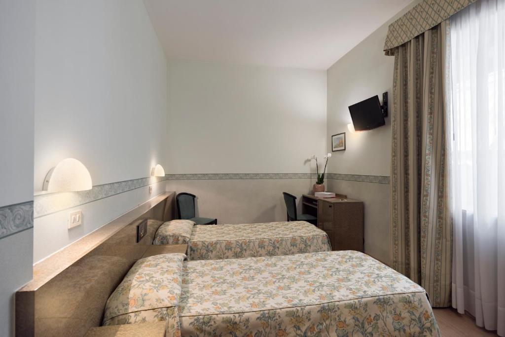 Postel nebo postele na pokoji v ubytování Hotel Garibaldi