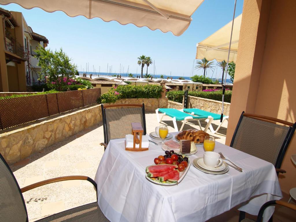 a table with a plate of food on a balcony at Apartment Son Durí seawiews 13 in Sa Ràpita