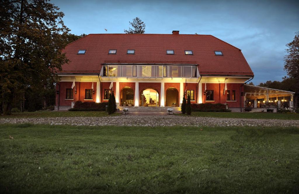 a large red house with a red roof at Annas Hotel - Design Hotel Spa Restaurant in Annas