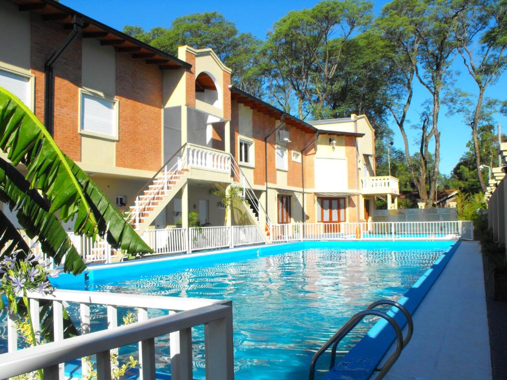 a swimming pool in front of a building at Casa Di Aqua Apart Hotel in Concordia