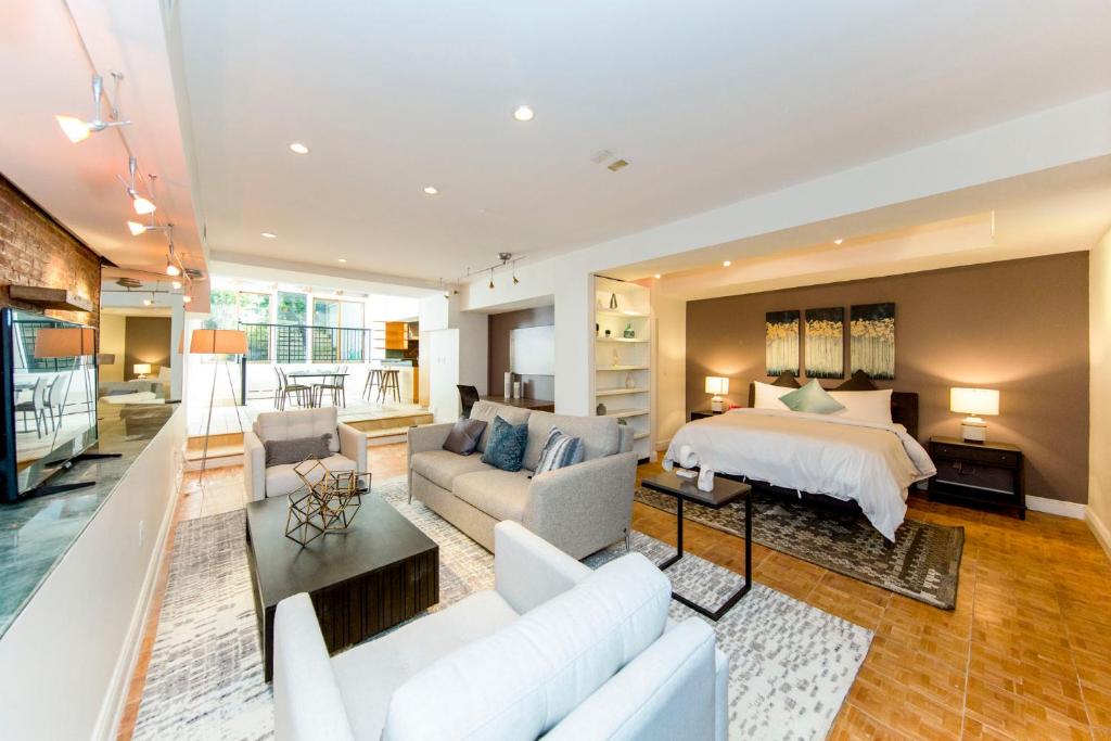 ein großes Wohnzimmer mit einem Bett und einem Sofa in der Unterkunft Chelsea Pines Inn in New York