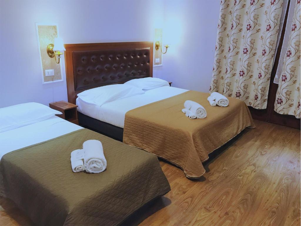 Postel nebo postele na pokoji v ubytování Hotel Aida