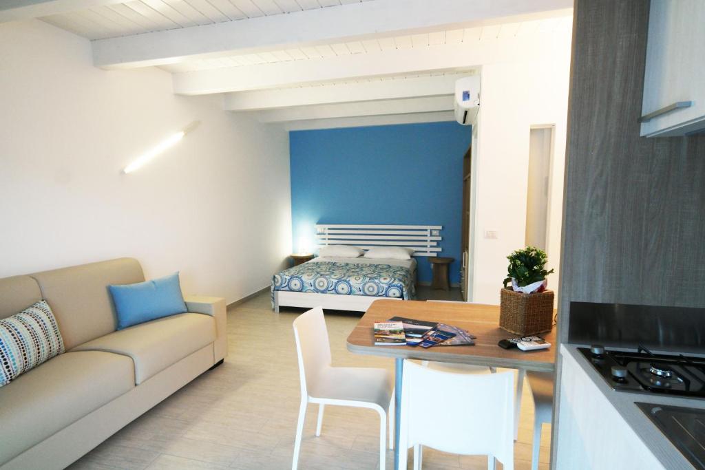 a living room with a couch and a table and a bed at Casa Dante Bed&Breakfast in Mattinata