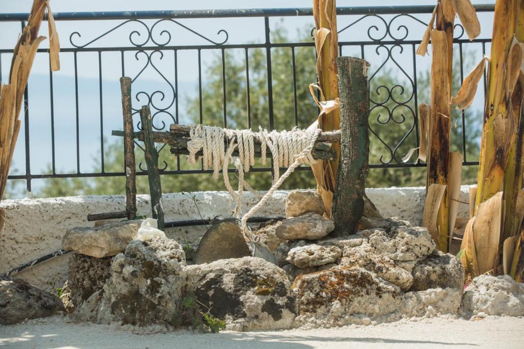 a fence with a rope hanging from it next to rocks at Summer Dream in Vlachata