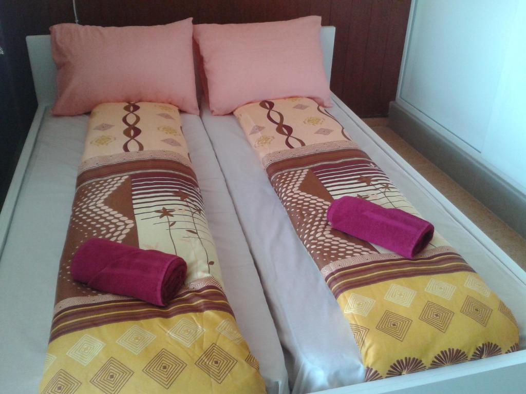 two beds with pillows on them in a room at Osogovo Rooms in Sofia