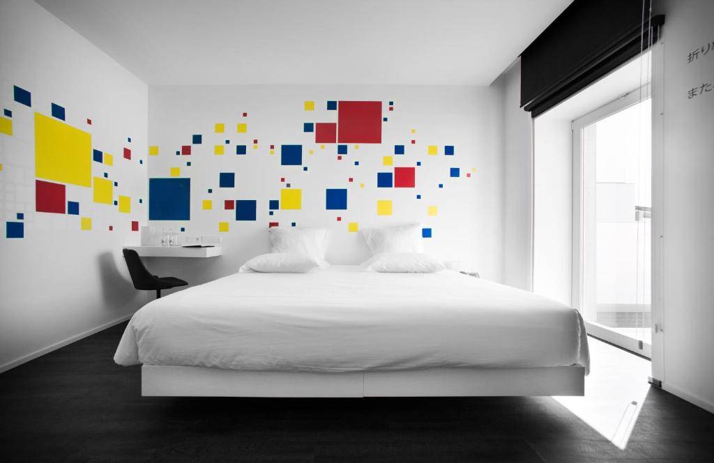 Postel nebo postele na pokoji v ubytování Design & Wine Hotel