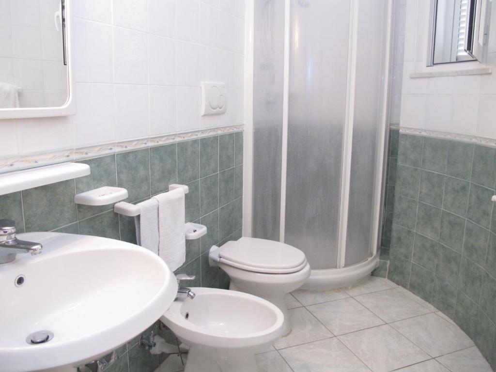 a bathroom with a sink and a toilet and a shower at Aparthotel Villa Marinù in Ischia