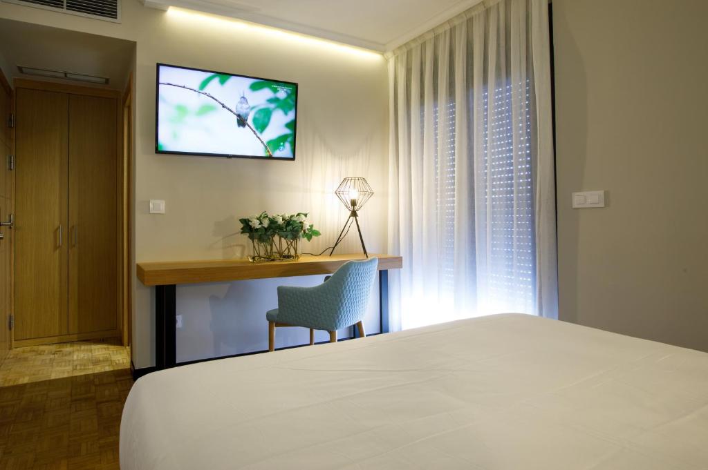 Televízia a/alebo spoločenská miestnosť v ubytovaní Hotel Val Convention