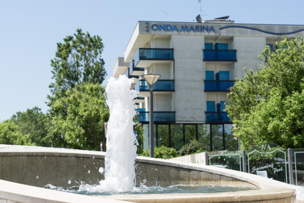 a water fountain in front of a building at Hotel Onda Marina in Misano Adriatico