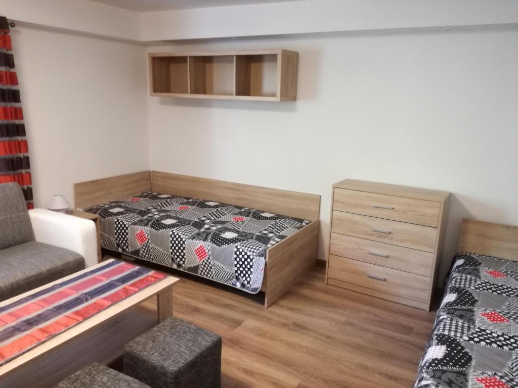 A bed or beds in a room at Apartmány Lenko - near thermal aquapark Tatralandia