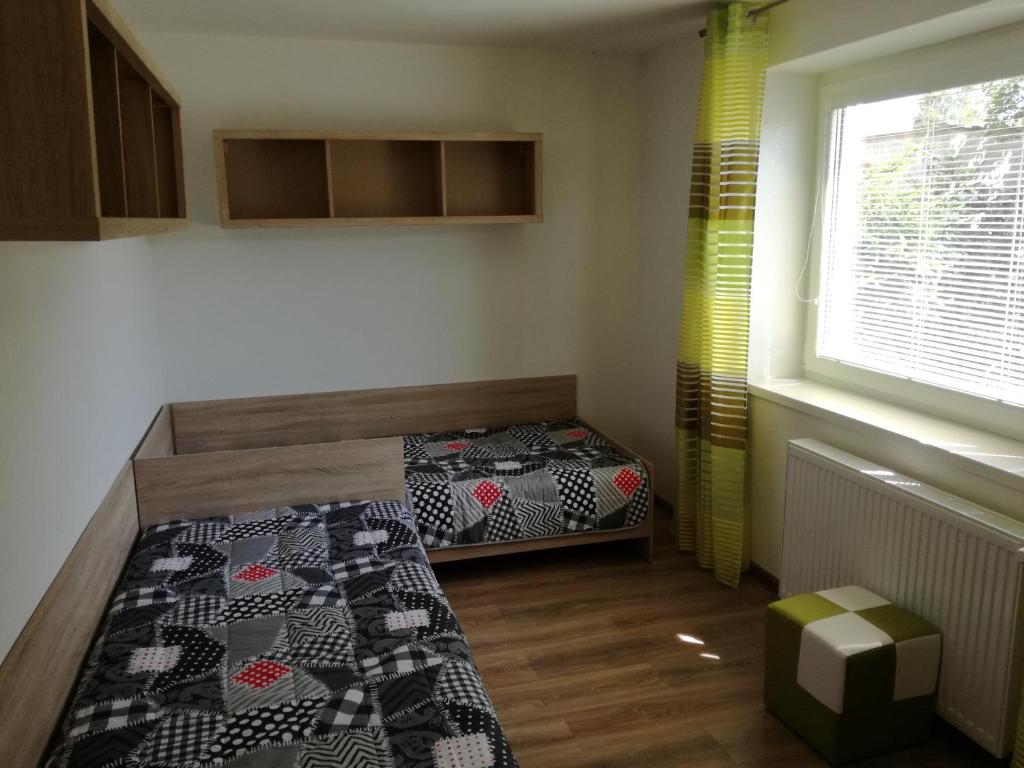 A bed or beds in a room at Apartmány Lenko - near thermal aquapark Tatralandia