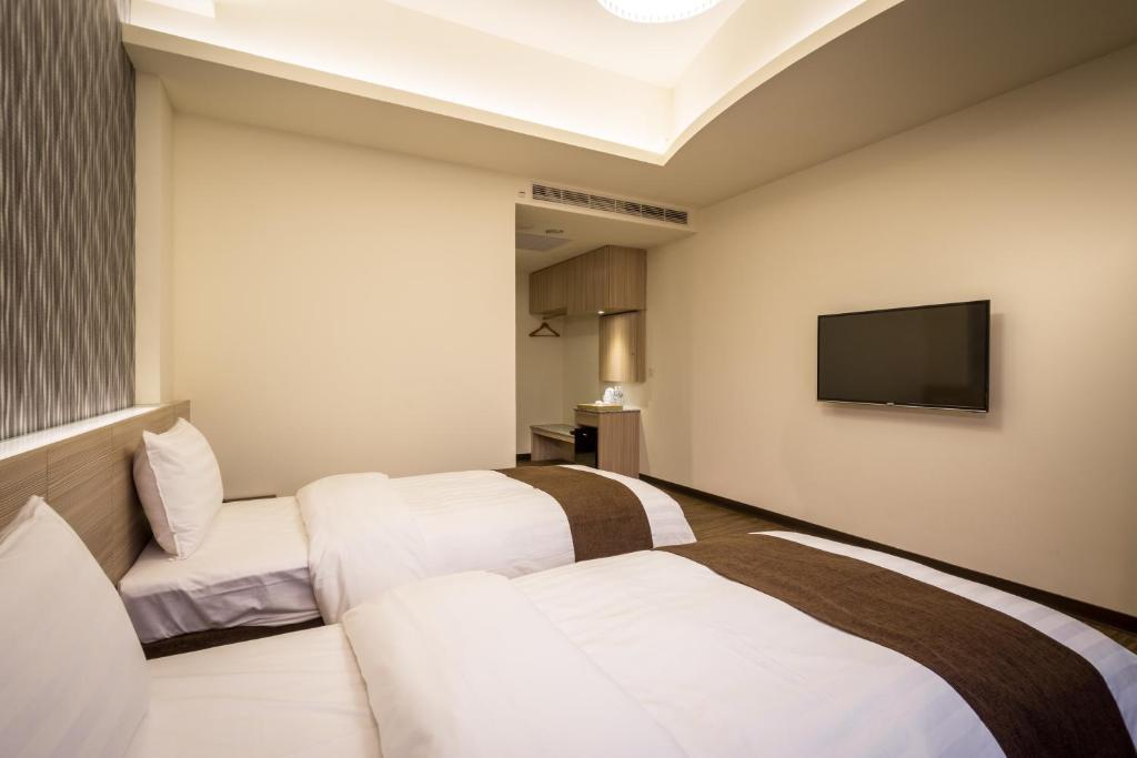 Postel nebo postele na pokoji v ubytování Midu Business Hotel