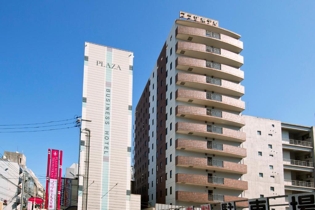 a tall building next to two tall buildings at Kagoshima Plaza Hotel Tenmonkan in Kagoshima