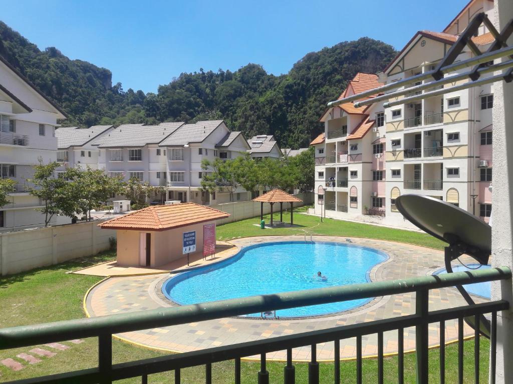 a view from a balcony of a swimming pool with buildings at Jeffrey Homestay B @ Lost World of Tambun in Ipoh