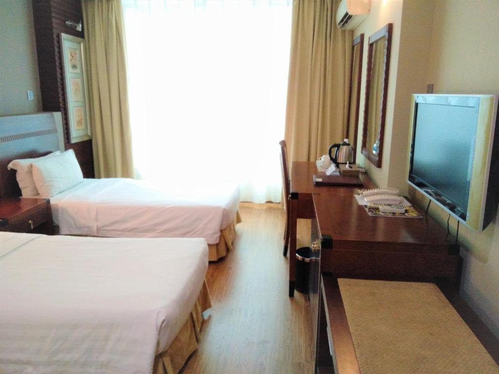 Postel nebo postele na pokoji v ubytování Celyn Hotel City Mall
