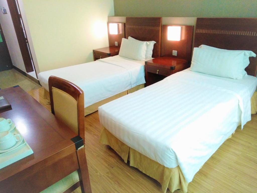 Postel nebo postele na pokoji v ubytování Celyn Hotel City Mall