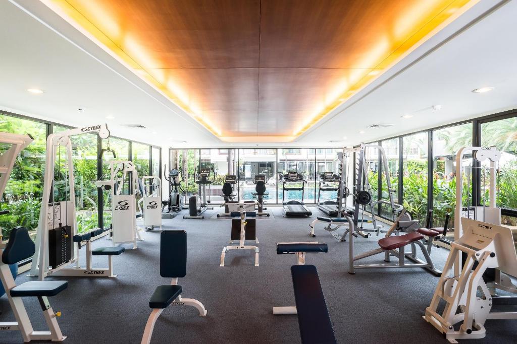 A long, symmetrical fitness room lined with cardio and resistance machines.