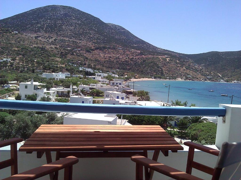 a bench on a balcony with a view of the ocean at Agnanti Apartments in Vathi